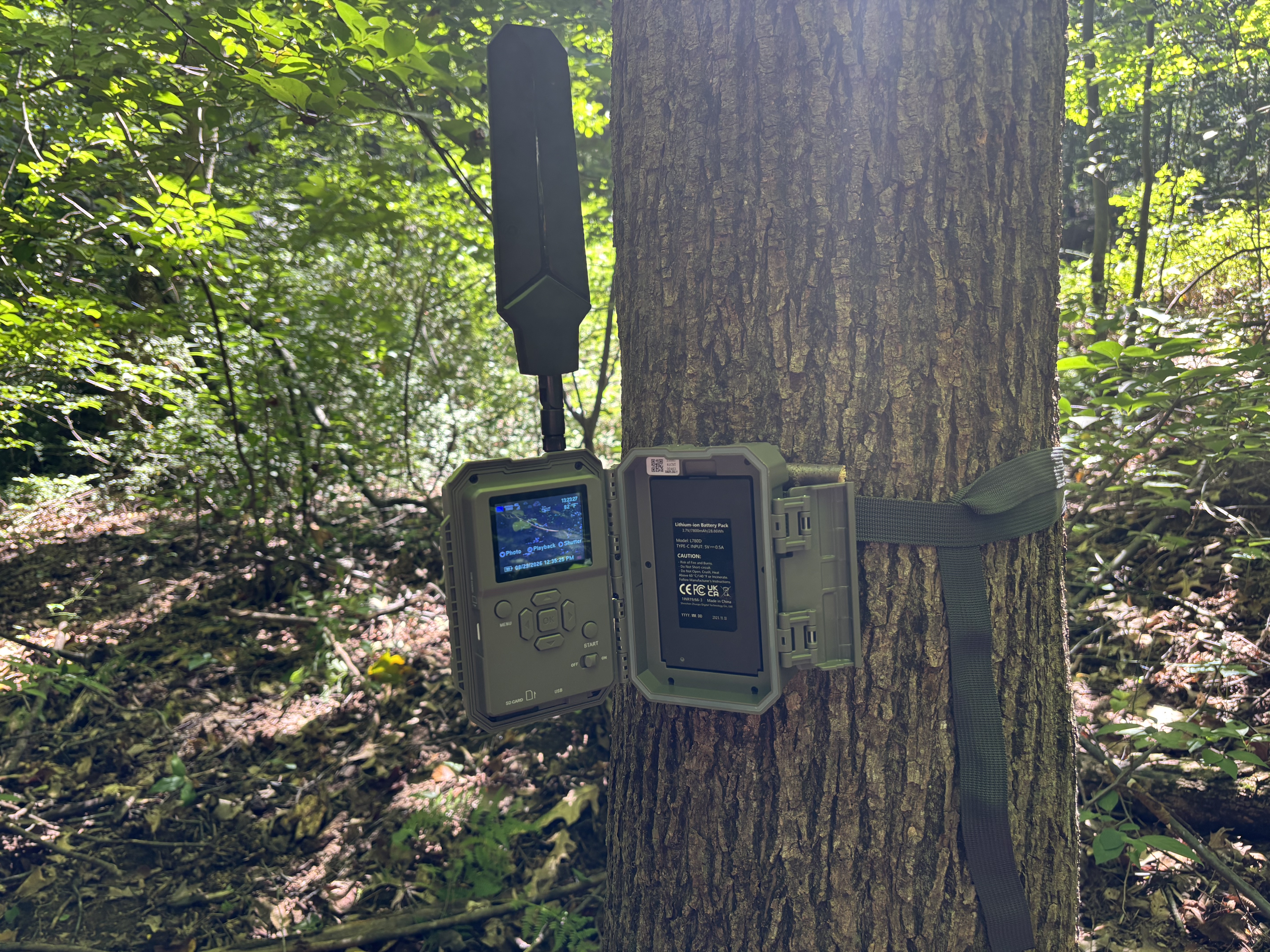 GardePro X66 housing open showing the control screen and removable lithium battery pack